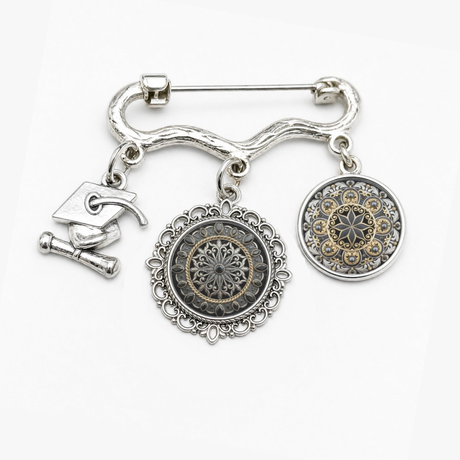 Black and gold baroque-style brooch with two round photo charms and a graduation cap charm