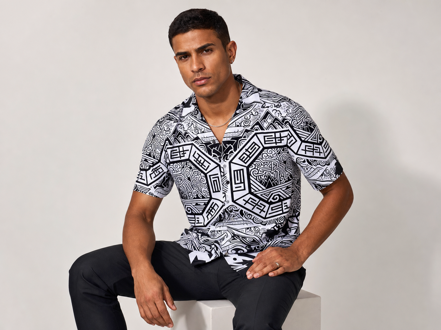 Male model wearing the Rich and Rich Men’s Multicolor Colorblock Designer Shirt with a boxy fit, short sleeves, notch lapel collar, and bold multicolor colorblock pattern.