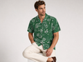 Male model wearing the Rich and Rich Men’s Green Fusion Designer Shirt with a boxy fit, short sleeves, notch lapel collar, and modern green fusion designer pattern.