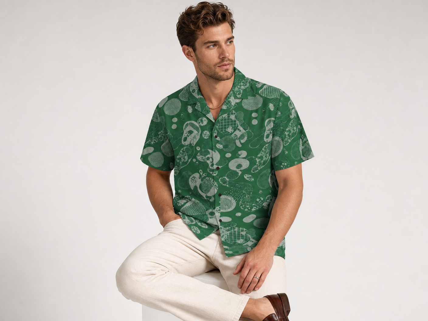 Male model wearing the Rich and Rich Men’s Green Fusion Designer Shirt with a boxy fit, short sleeves, notch lapel collar, and modern green fusion designer pattern.