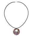 Handmade purple abstract wooden pendant with organic shapes on black faux suede cord