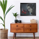 Framed canvas print of black butterfly and caricature figure in swept frame — product detail