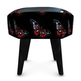 Hexagonal black velour footstool with butterfly design, plush upholstery — side view