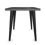Small side table with artistic butterfly and caricature surface design and slender legs — rear view
