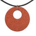 Orange Feng Shui inspired wooden pendant necklace with organic shapes on black faux suede cord
