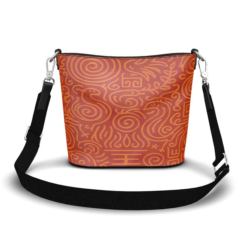 Large orange abstract Nappa leather bucket tote with magnetic closure, adjustable strap and faux suede lining — side view