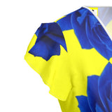 Women's tea dress with yellow and blue rose print, flounce hem and waist tie with buttonhole — rear view