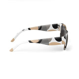Round unisex sunglasses with earthtone circular dimension print and slim arms — side view