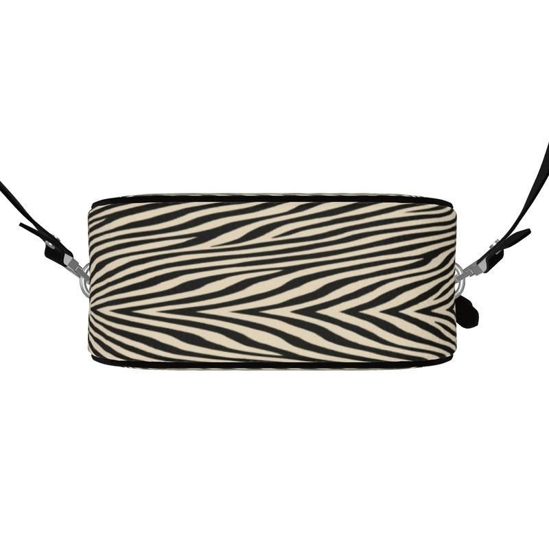 Round box shoulder bag in Nappa leather with faux suede lining and black leather piping — side view
