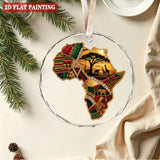 Round crystal glass ornament depicting the African continent with red ribbon and gift box — side view