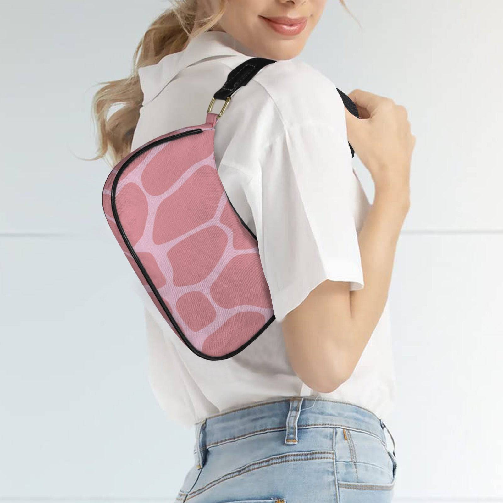 Pink safari-print women's shoulder bag with curved top, black strap and leather edge detailing