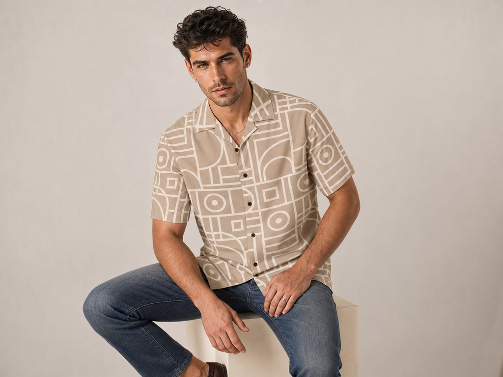 Male model wearing the Rich and Rich Men’s Beige Vertex Designer Shirt with a boxy fit, short sleeves, notch lapel collar, and modern beige vertex designer pattern.