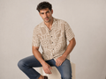 Male model wearing the Rich and Rich Men’s Beige Vertex Designer Shirt with a boxy fit, short sleeves, notch lapel collar, and modern beige vertex designer pattern.