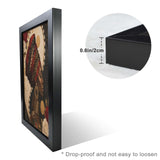Black-framed canvas print of a portrait of a woman, 24 by 36 inches — rear view