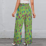 Green floral wide-leg women's pants with elastic waistband, tied belt, and side pockets — side view