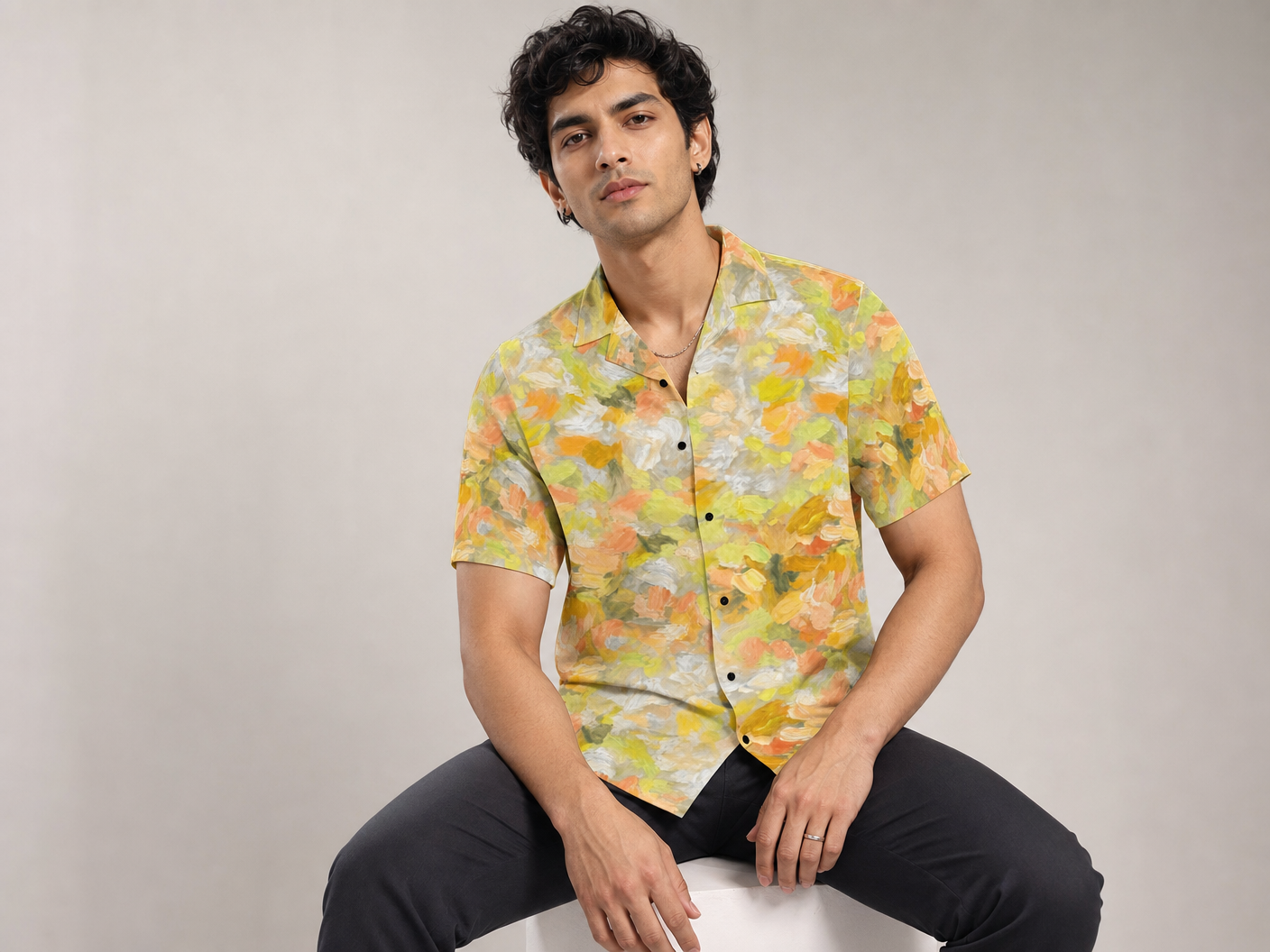 Male model wearing the Rich and Rich Men’s Yellow Sunshine Designer Shirt with a boxy fit, short sleeves, notch lapel collar, and bright yellow sunshine designer pattern.