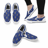 Blue canvas slip-on shoe with musical notes print, cushioned footbed and elastic goring — side view