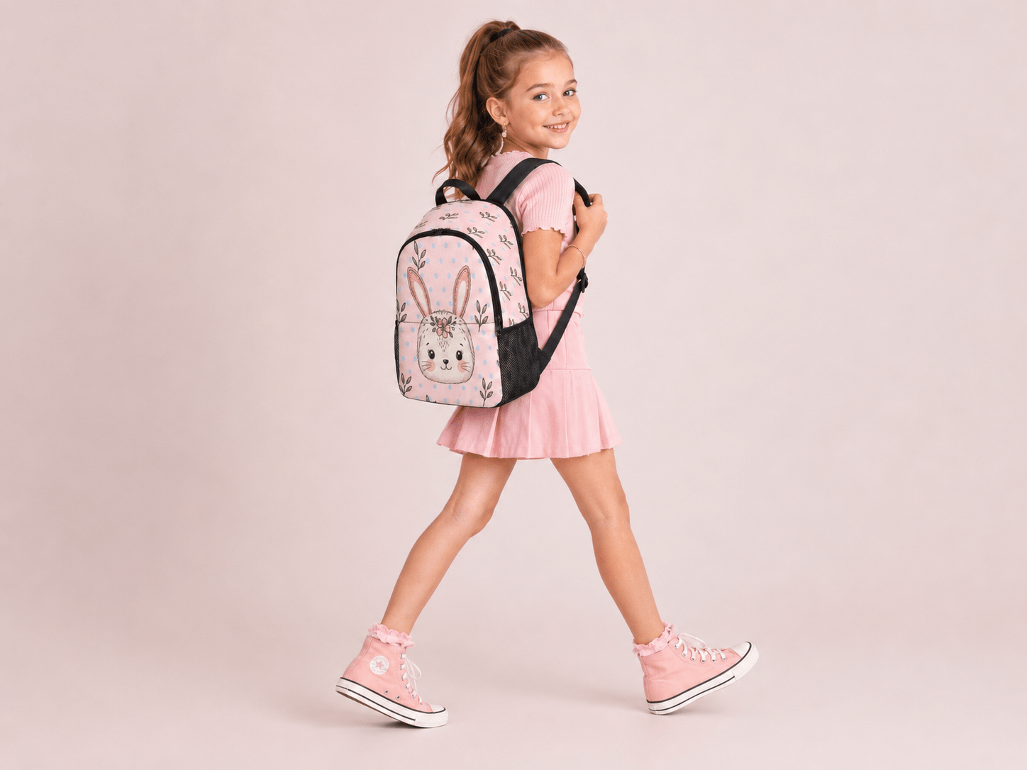 Pink and white girls' backpack with bunny faces, light blue polka dots, and coral ear accents