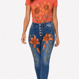 Coral tee with large orange and gold tiger lily blooms paired with high-waist denim embroidered with matchin — product detail