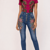 Fuchsia tee with gold and emerald twin dragon graphic paired with denim embroidered with floral and scale mo — alternate view