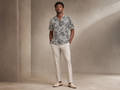 Male model wearing the Rich and Rich Men’s Gray Fusion Designer Shirt with a boxy fit, short sleeves, notch lapel collar, and modern gray fusion designer pattern.