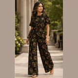 Two-piece women's set with black roses and gold accents, side-tie top and wide-leg pants — rear view