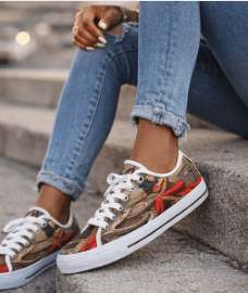 Red low-top women's sneaker with all-over caricature print and flexible rubber sole — alternate view