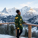 Women's emerald green puffer coat with yellow tulip floral print and detachable hood