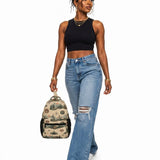 Beige 17-inch backpack with front pocket, mesh side pockets, padded straps, and orange buckle detail — alternate view