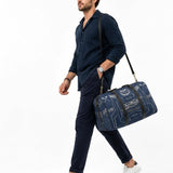 Blue weekender duffel with lacrosse-inspired artwork, PU leather handles, and adjustable shoulder strap — product detail