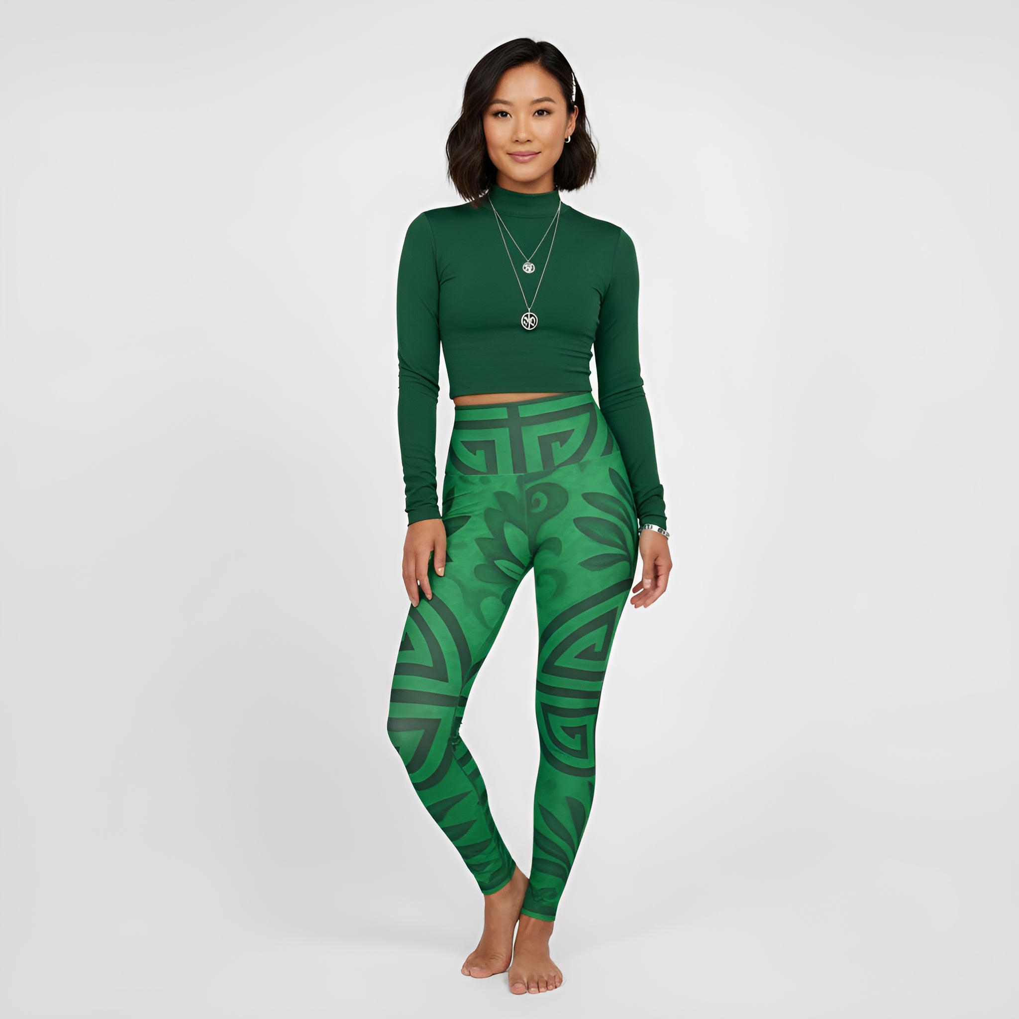 High-waisted emerald green yoga leggings with all-over Feng Shui print and smooth waistband