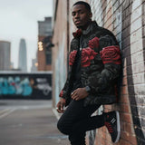 Men's black and red puffer jacket with bold rose floral print and front pockets — additional view 10