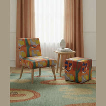 Orange abstract upholstered occasional chair with tapered wooden legs, 29" tall