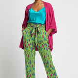 Green floral wide-leg women's pants with elastic waistband, tied belt, and side pockets