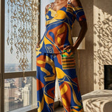 Women's blue multicolor pants set with off-shoulder V-neck top and navy blazer — rear view