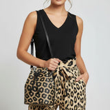 Black women's V-neck sleeveless tank top with chest pockets and side slits