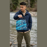 Blue trapezoid insulated lunch bag with outdoor kayaking-inspired design and carry handle — alternate view