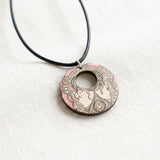 Pink wooden pendant with organic abstract shapes on a black faux suede cord with silver clasp — additional view 6