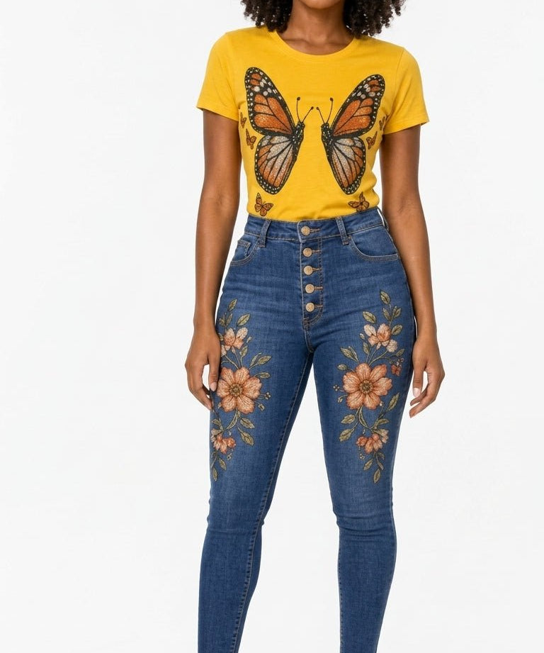 Sunflower yellow tee with monarch butterfly graphic paired with high-waist blue jeans with floral embroidery
