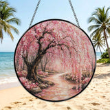Glass suncatcher with Japanese blossom tree print hanging from a metal chain — side view