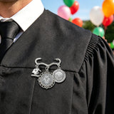 Chess Girl Talk decorative metal brooch with two round photo charms and a small graduation cap charm on a pin — rear view