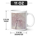 White 11 oz ceramic mug decorated with cherry blossom tree artwork and a crystal sticker decorative finish — rear view