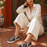 Blue slip-on canvas shoes with leopard saxophone artwork and cushioned footbed