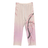 Pink drawstring lounge pants with Japanese cherry blossom print and elastic waistband, shown folded — rear view
