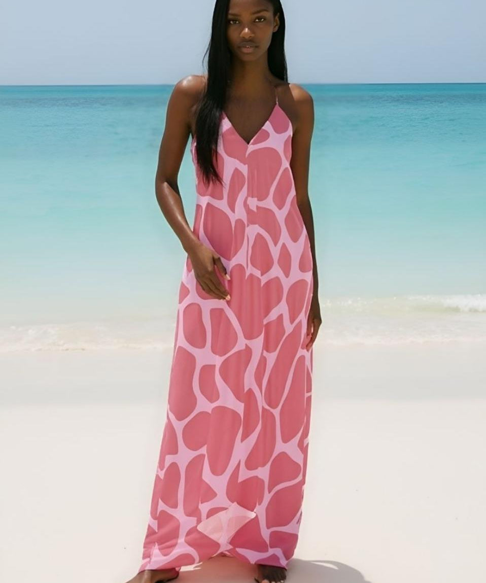 Pink abstract halterneck backless dress in silky fabric with low-cut back and flowing silhouette