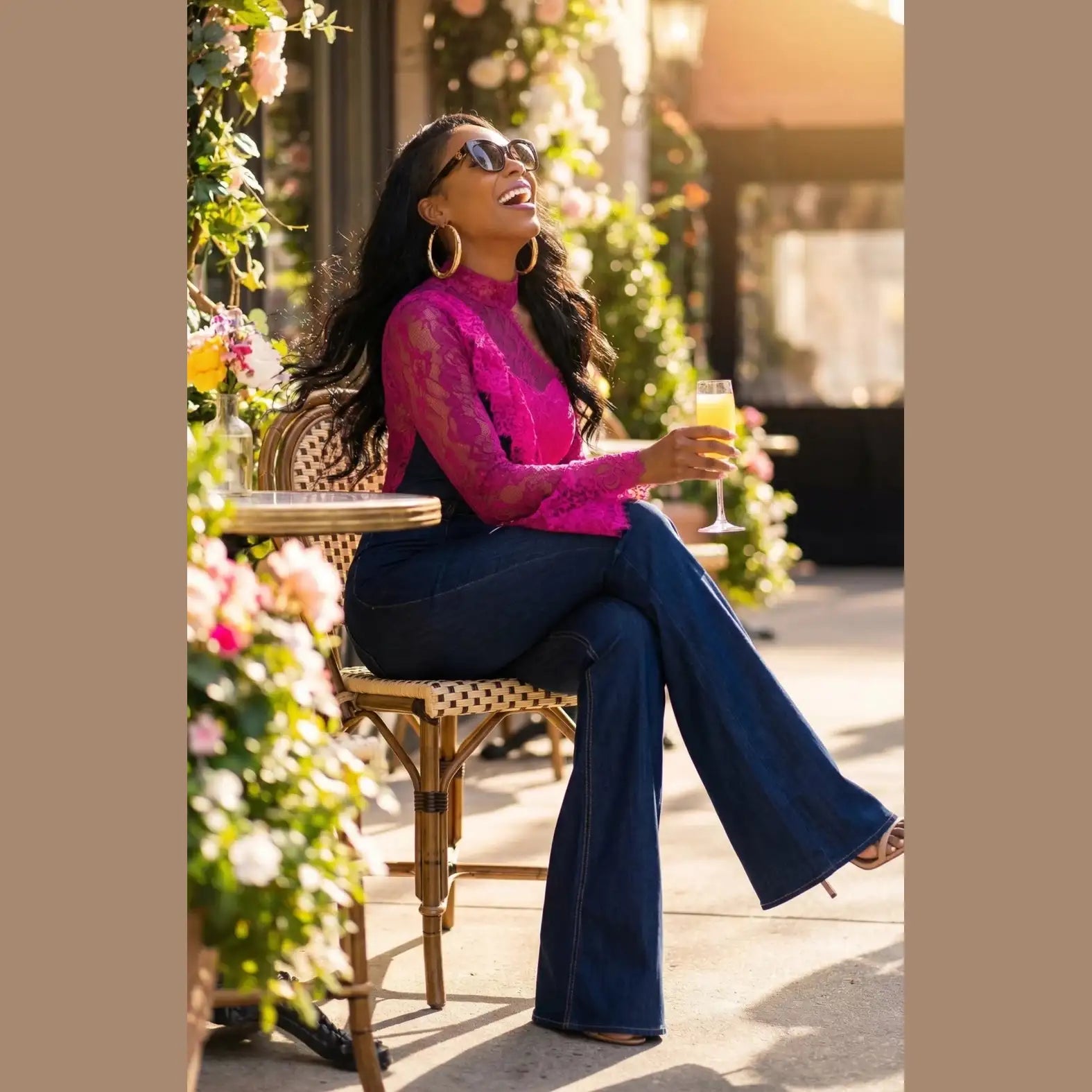 Women's dark denim Tencel jumpsuit with fuchsia lace accents on sleeves, bodice and one leg — side view