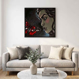 Framed canvas print of black butterfly and caricature figure in swept frame — rear view